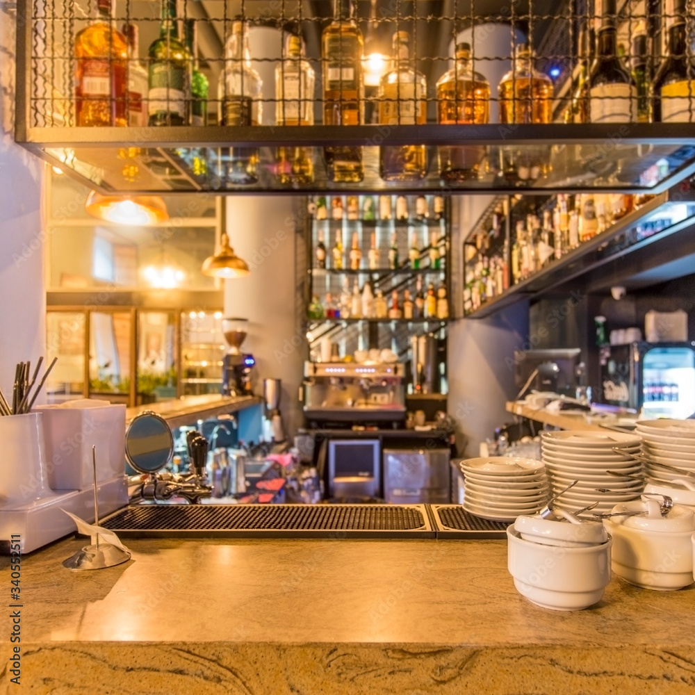 Clean dishes and view on bar counter in restaurant interior