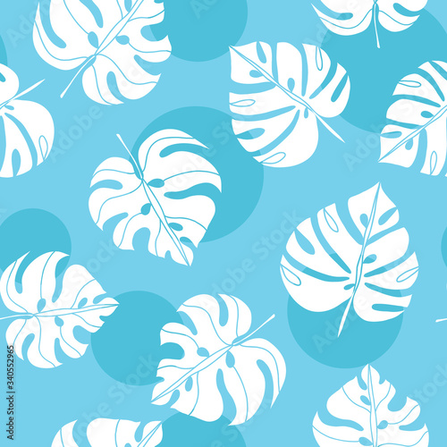 Trendy seamless pattern with monstera leaves on blue background with circles