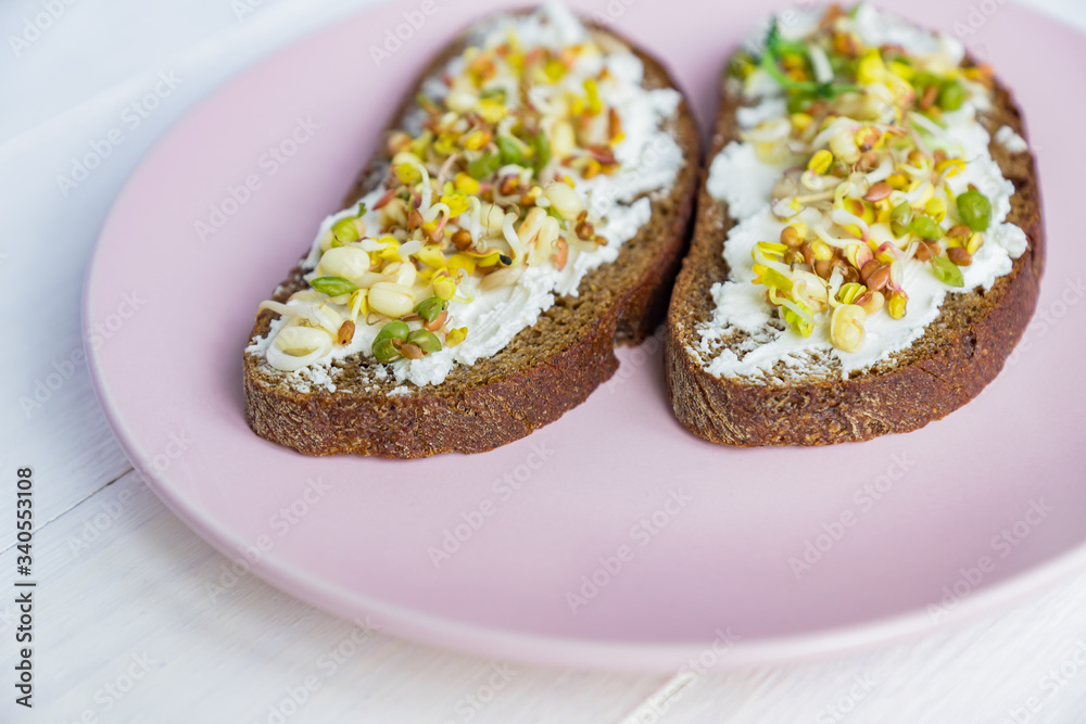 Top view of rye bread sandwiches with cream cheese and sprouted mung beans, walnut, sunflower and flax. raw food diet. Top view of rye bread sandwiches with cream cheese and sprouted mung beans, walnut, sunflower and flax. raw food diet.