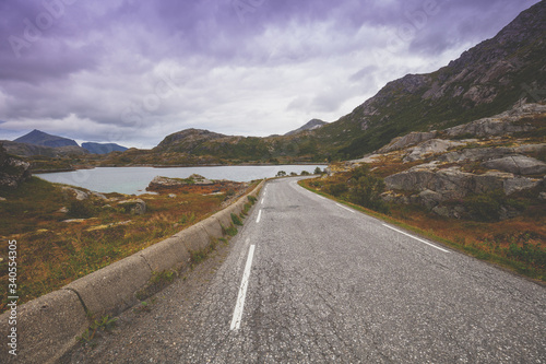 Winding road along mountains and fjord, Scandinavian landscape. Beautiful nature of Norway