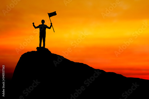 success and silhouette of businessman holding winner flag on mountain  leader  achievement and win concept