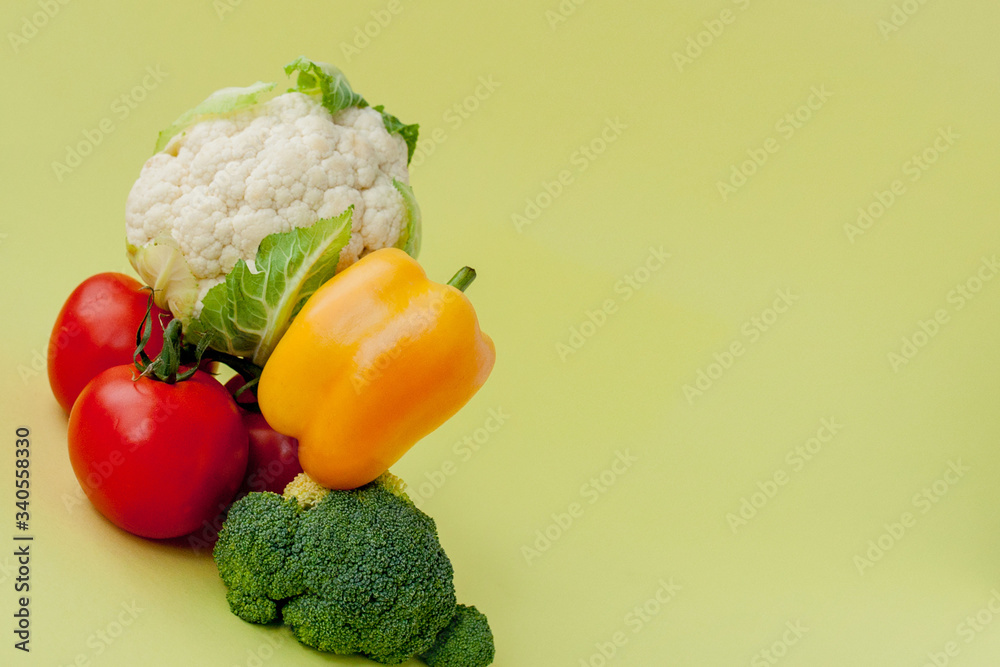 Healthy clean eating layout, vegetarian food and diet nutrition concept. Various fresh vegetables ingredients for salad on yellow table background, top view, frame, banner.