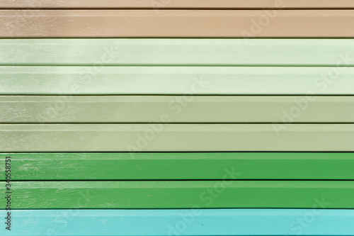 Multicolored vinyl siding with simulated wood texture. Plastic wall covering for exterior decoration of house. Abstract background for your design