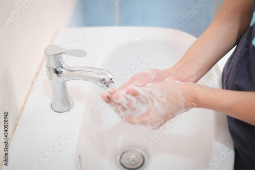 Woman washing hands, Corona virus travel prevention wash hands with soap and hot water. Hand hygiene for coronavirus outbreak. Protection by washing hands frequently concept.