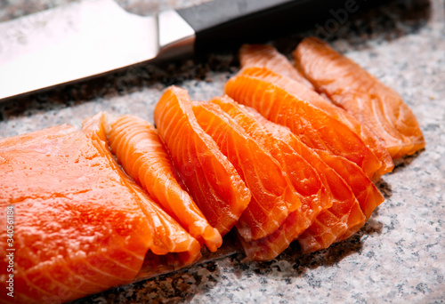 freshly marinated salmon Carpaccio sliced on granite marble cutting board
