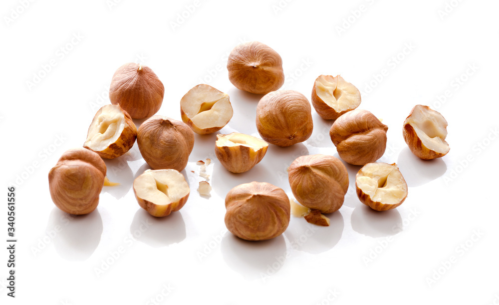 Full and halfs of hazelnuts on white background. Isolated Full and halfs of hazelnuts on white background. Isolated