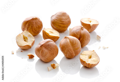 Full and halfs of hazelnuts on white background. Isolated