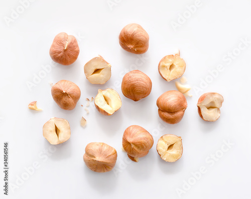 Full and half of hazelnuts on white background top view. Isolated photo