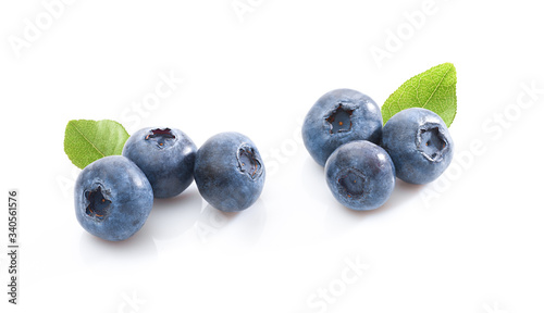 Groups of blueberries with leaves on white background. Isolated