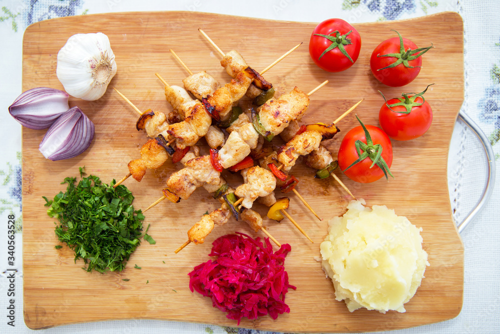 Set of Shish Kebabs . beef kebab on a wooden board . Red cabbage sauerkraut . mashed potatoes . Garlic, Onion, Tomatoes. Chopped coriander . Lamb kebab on a wooden skewer . Set of Shish Kebabs . beef kebab on a wooden board . Red cabbage sauerkraut . mashed potatoes . Garlic, Onion, Tomatoes. Chopped coriander . Lamb kebab on a wooden skewer .