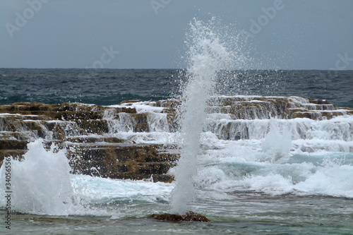 Sea blowholes on coral coast with tall geysers, Mapu 'A Vaea, Tonga photo