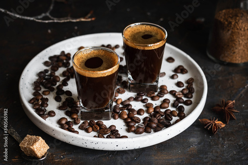 Espresso coffee in two glasses. Dark background. Dark style