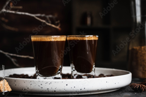 Espresso coffee in two glasses. Dark background. Dark style