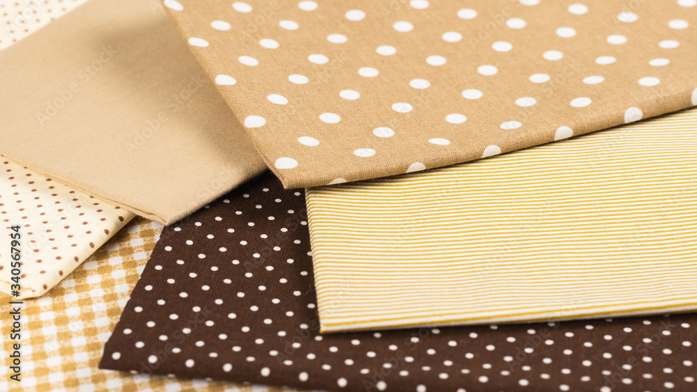Mix of beige, white and brown cotton fabric. Mix of beige, white and brown cotton fabric.