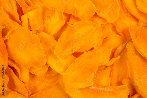 Tasty sugar mango slices background. Top view.