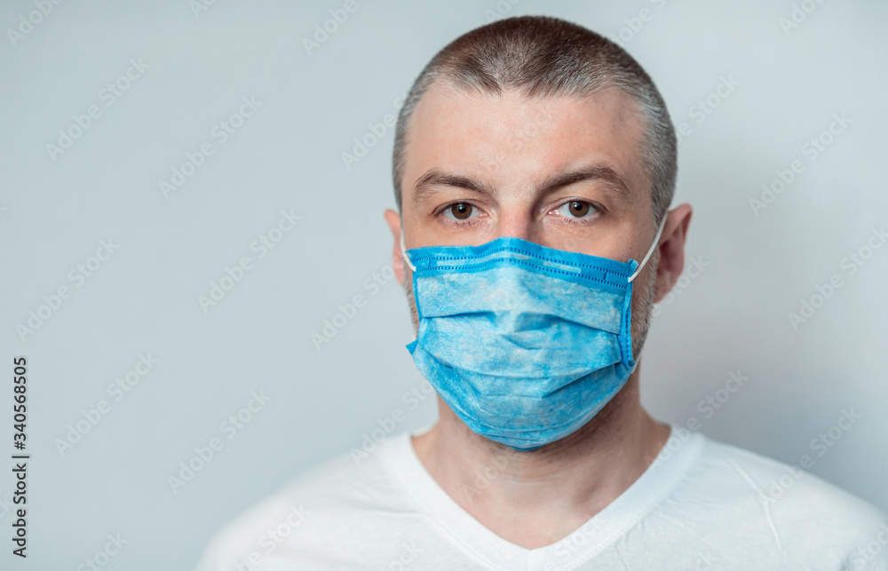 Sick Man Wearing Mask Looking At Camera On Gray Background Sick Man Wearing Mask Looking At Camera On Gray Background