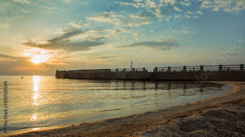 Sunset on the Mediterranean sea. Silhouettes of fishermen on the breakwaters. Beautiful sunset on the beach . Fishermen by the sea at sunset . Beautiful embankment on the Caspian Sea in Baku .Sunset .