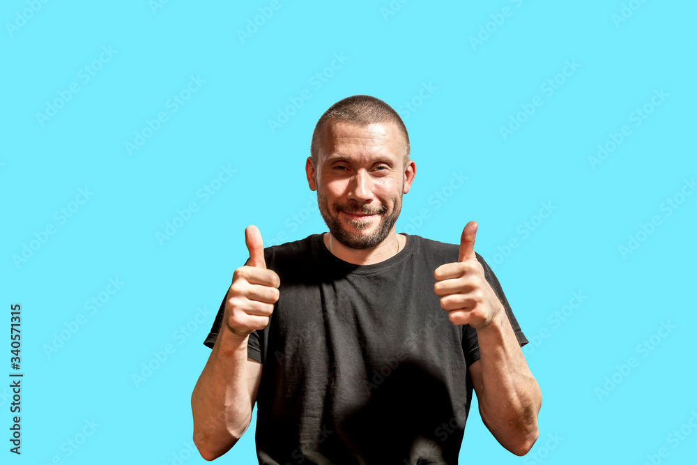 The happy man is filmed isolated on a blue background The happy man is filmed isolated on a blue background