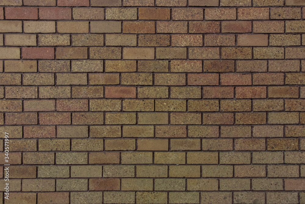 Small bricks red and broen color arranged in rows on the wall