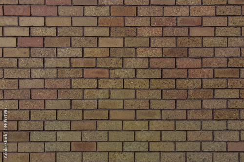 Small bricks red and broen color arranged in rows on the wall