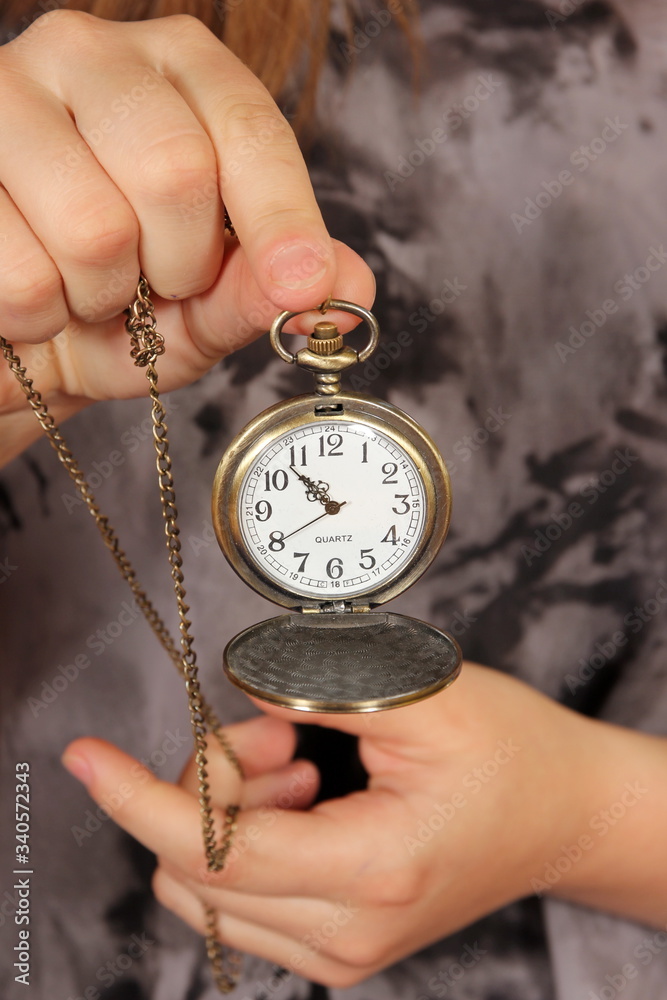 Hands with an old antique clock with a chain Hands with an old antique clock with a chain