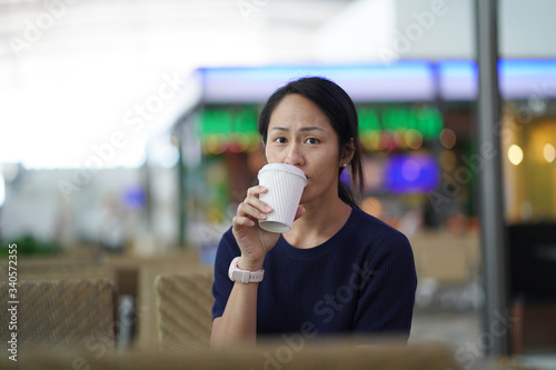 Asian chinese woman sitting at a coffee joint