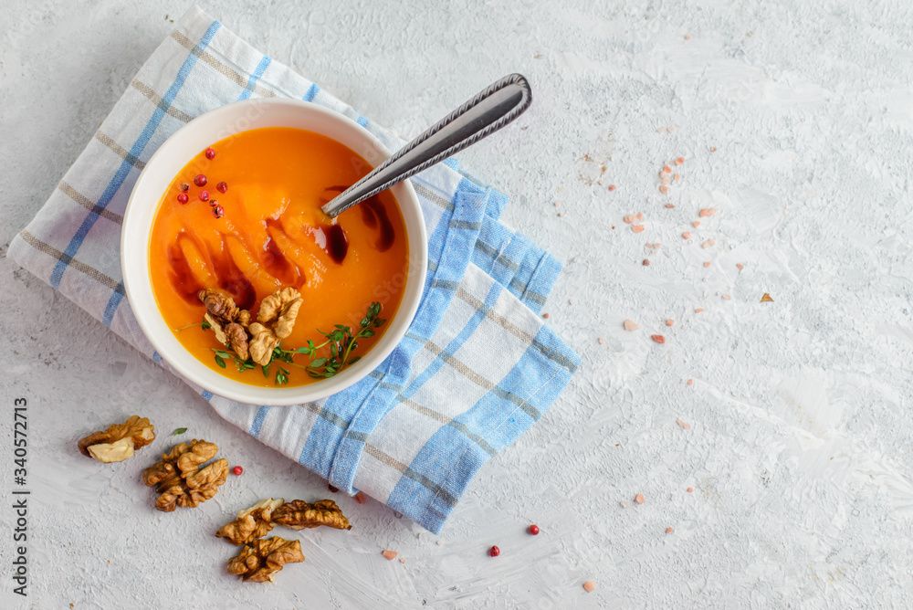 Creamy pumpkin soup-puree in a bowl on light background Creamy pumpkin soup-puree in a bowl on light background