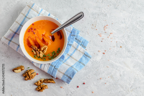 Creamy pumpkin soup-puree in a bowl on light background 