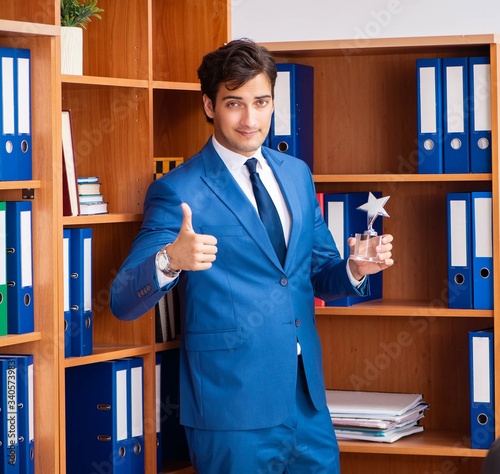 Young employee working in the office photo