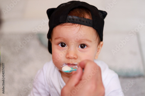 Happy baby eating yogurt