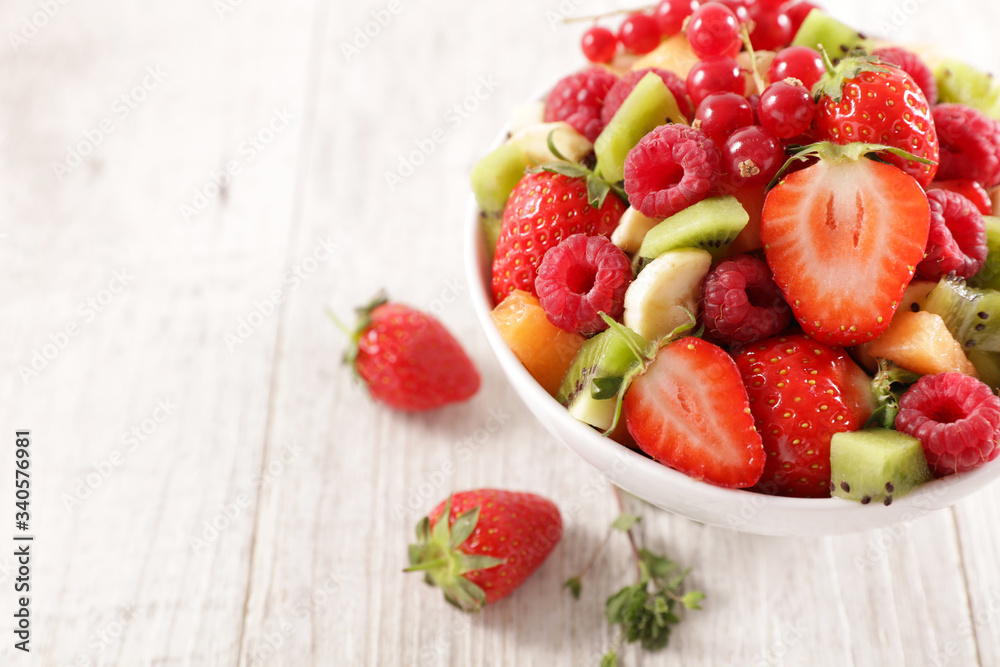bowl of mixed fresh fruits- berry fruit, orange, kiwi and banana bowl of mixed fresh fruits- berry fruit, orange, kiwi and banana