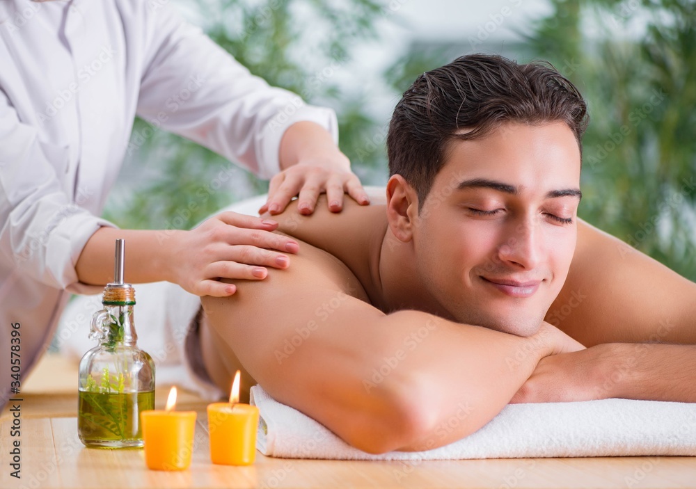 Handsome man during spa massaging session Handsome man during spa massaging session