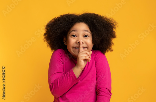 Keep Silence. Little Black Girl Showing Shh Sign On Yellow Background photo