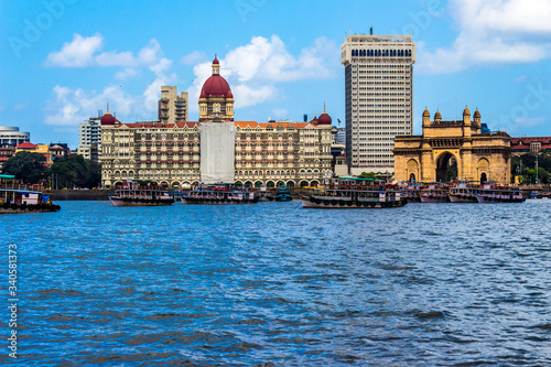 Three famous monuments in a single photo. The old Taj Hotel building, the new Taj Hotel building and the Gateway of India, Mumbai, Maharashtra, India on the banks of Arabian Sea.