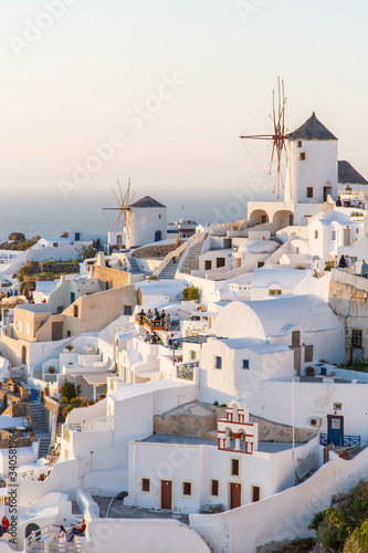 Beautiful view of famous romantic white town Oia in Santorini Island, Greece at sunset