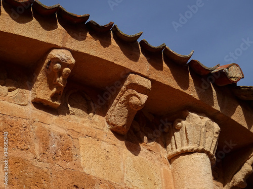 Detail of cornice and brackets of the Romanesque Church of San Miguel. (12 Century). Village of Ayllon. Segovia. Spain. photo