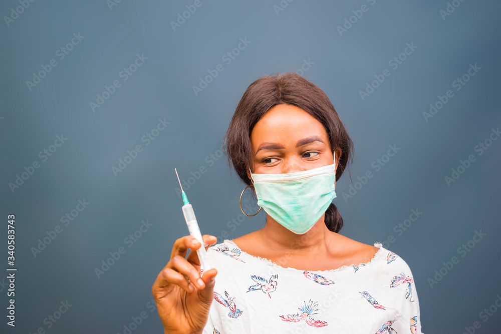 coronavirus epidemic from china. selective focus. woman doctor use syringe. nurse make injection in respirator mask. health worker dials vaccine in syringe. Physician or giving vaccine against virus coronavirus epidemic from china. selective focus. woman doctor use syringe. nurse make injection in respirator mask. health worker dials vaccine in syringe. Physician or giving vaccine against virus