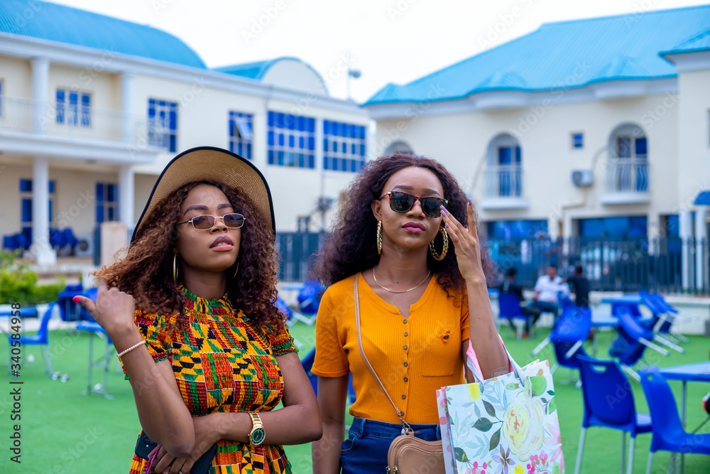 young beautiful black ladies holding some shopping bags