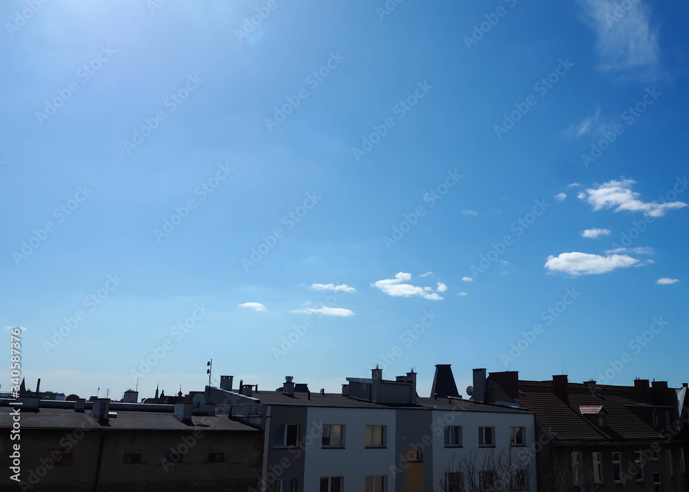 Houses against a blue sky with white clouds Houses against a blue sky with white clouds