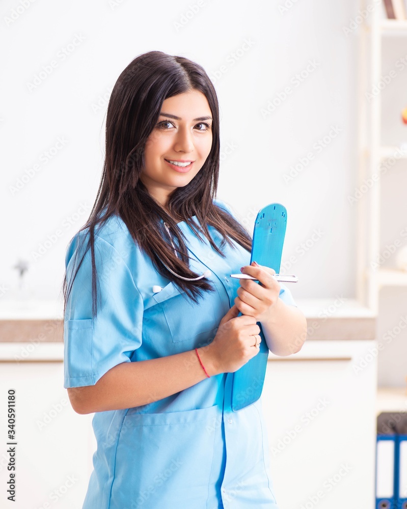 Young beautiful female doctor working in the clinic Young beautiful female doctor working in the clinic