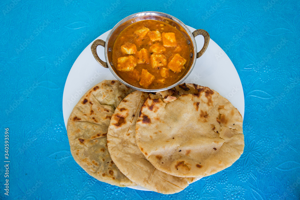Homemade shahi paneer served in a brass bowl made with lot of spices in ...