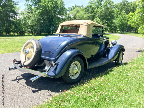 1934 Ford Roadster blue in park on green grass outdoor sky