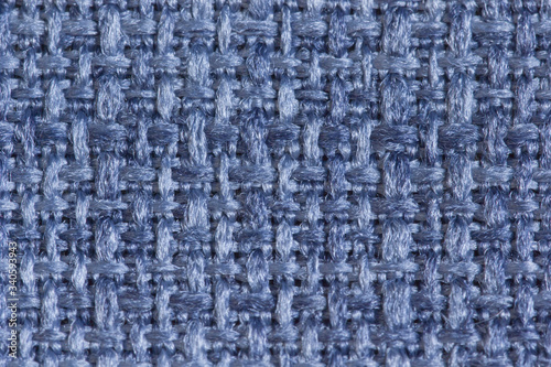Abstract background from upholstery fabric guns for furniture in a large knit of blue threads in macro, empty template. Gunny. Large weaving of threads on the fabric.
