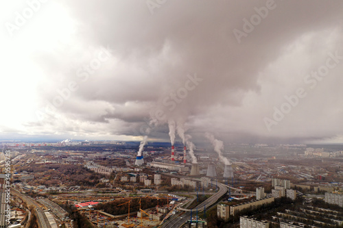 panoramic industrial city view with smoke pipes taken from a drone