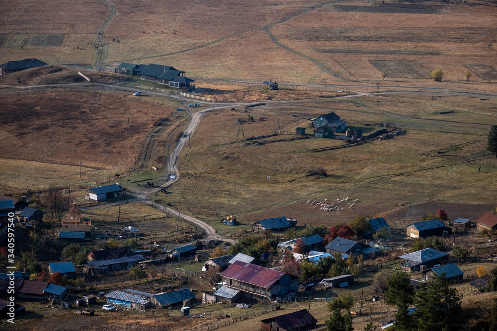 Obraz premium Landscape view of lower Omala in Tusheti with a herd of sheep walking on the right.