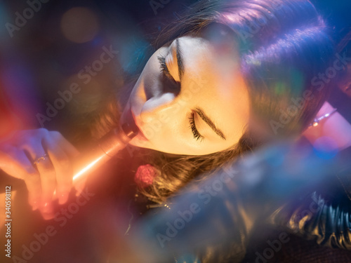 Vaper girl face top view. A woman smokes a vape. Student with a vape device. ???? women with an electronic cigarette. Concept - transient smoking electronic cigarettes. Buying vape devices