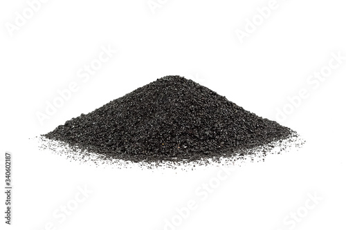 Abrasive powder black superslut in the form of slides on white background. Granulated slag is used for cleaning metal surfaces, from rust and paint. photo