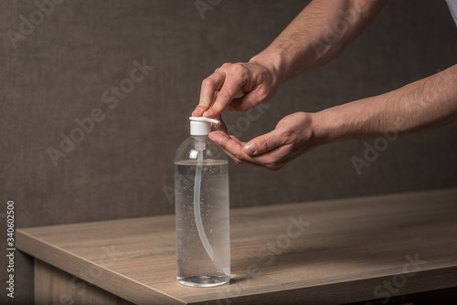 Hand sanitizer alcohol gel rub clean hands hygiene prevention of coronavirus virus outbreak. Man using bottle of antibacterial sanitiser soap. coronavirus, covid 19