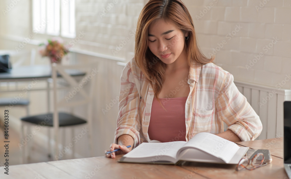 Close up shot of a university girl reading a final exam in the living room at home. Close up shot of a university girl reading a final exam in the living room at home.