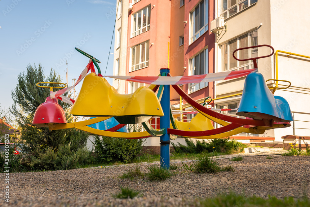 Playground wrapped in striped red white tape, stay home. Quarantine area for sports, prevention of infection with the covid-19 coronavirus influenza virus. no people